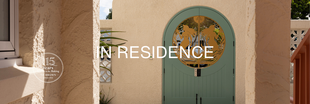 Arched walkway and decorative sage green gate at The Shores Miami, part of TH Brown’s In Residence design series.