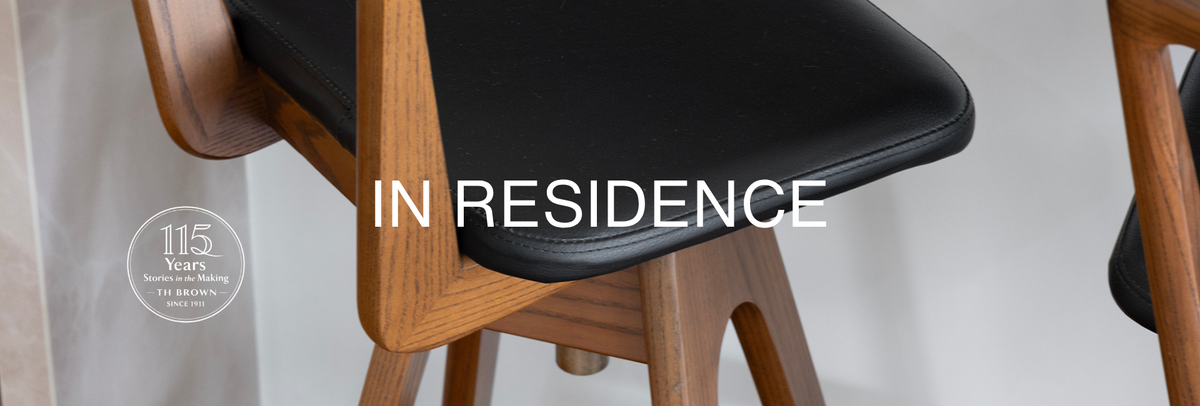 TH Brown Danish Bar Stool with timber frame and black leather seat at the kitchen island of a Holland Park West home, featured in TH Brown In Residence