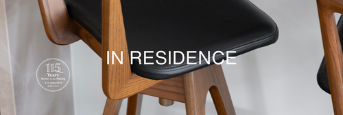 TH Brown Danish Bar Stool with timber frame and black leather seat at the kitchen island of a Holland Park West home, featured in TH Brown In Residence