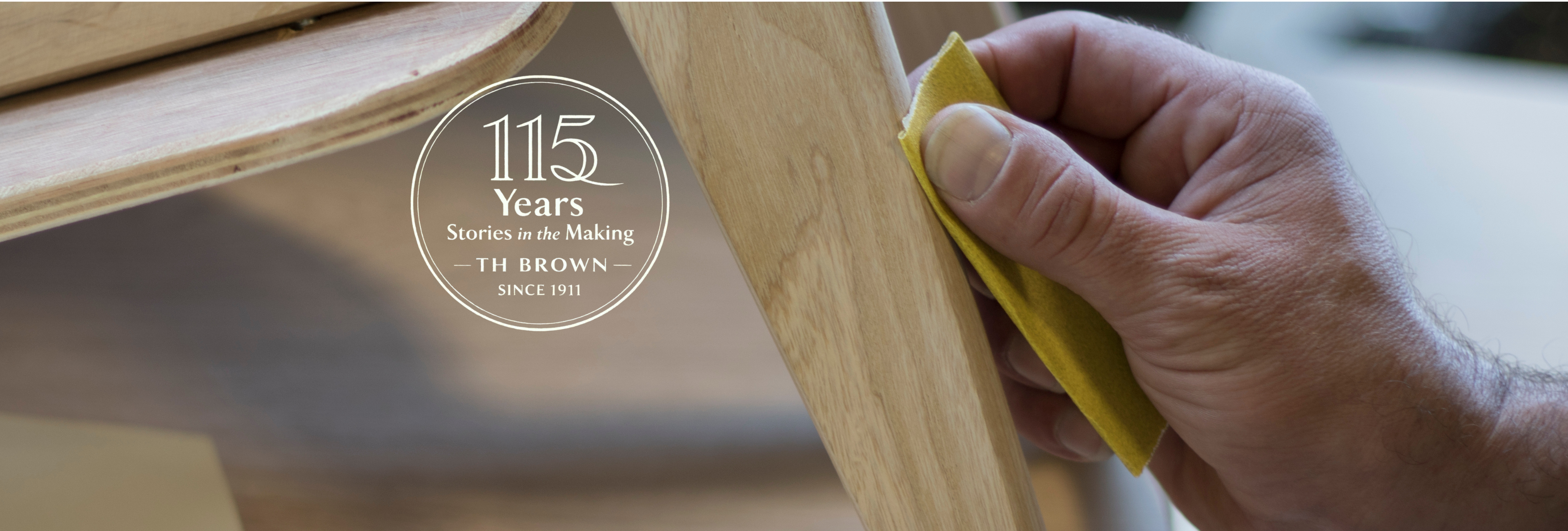 Craftsperson hand-sanding a timber TH Brown piece in the workshop