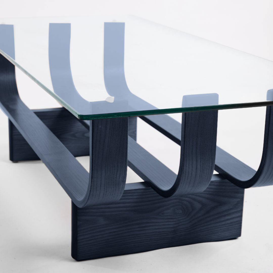 TH Brown Aquarius Coffee Table in Matt Black Ash with clear glass, blending natural timber warmth and sculptural form for timeless modern Australian living.