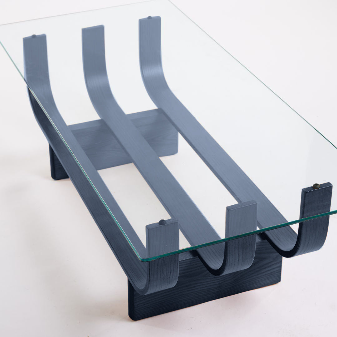 TH Brown Aquarius Coffee Table in Matt Black Ash with clear glass, blending natural timber warmth and sculptural form for timeless modern Australian living.