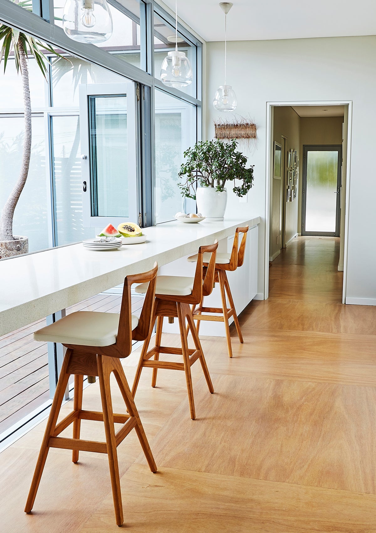 TH Brown Danish Bar Stools in timber and white upholstery at a modern kitchen bench, handcrafted Australian furniture made in Adelaide