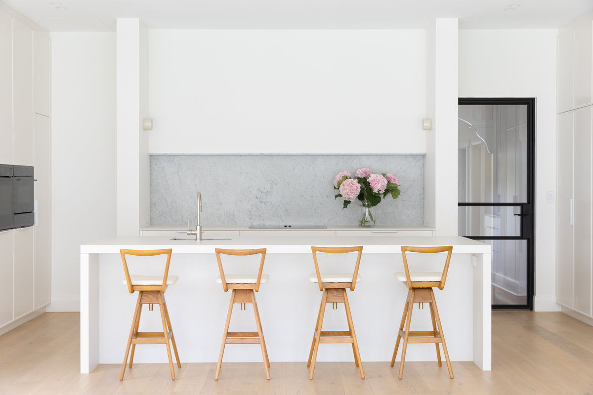 TH Brown Danish Bar Stools in timber with white upholstery at a contemporary kitchen island, handcrafted Australian furniture made in Adelaide