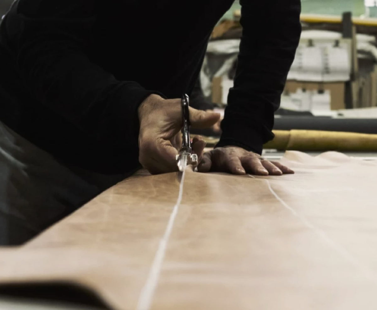 TH Brown craftsman cutting premium leather in the Adelaide workshop, showcasing Australian-made furniture craftsmanship
