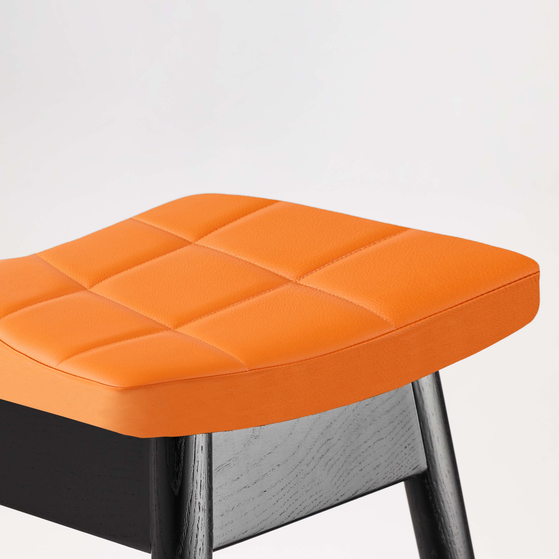 TH Brown Martelle Bar Stool in Calypso Orange with Matt Black frame, bringing vibrant color and bold contrast to modern Australian living.