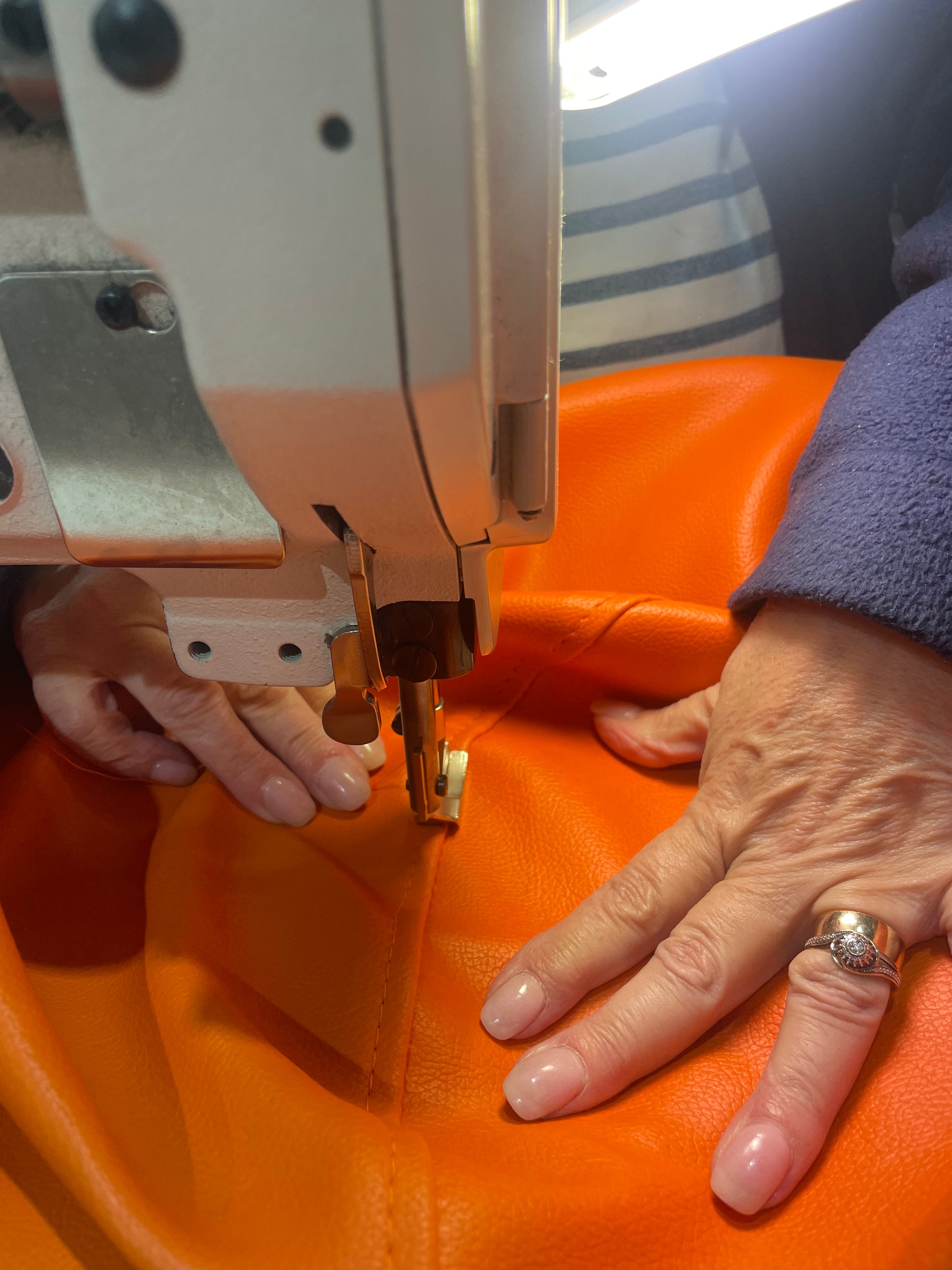 TH Brown Rondo Pouffe being sewn by hand, highlighting the craftsmanship and care behind Australian-made furniture.