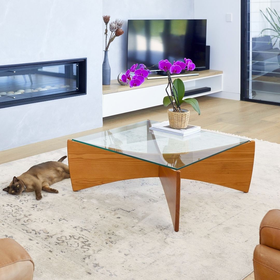 TH Brown Venus Coffee Table in Teak Ash, styled as a sculptural centerpiece in a light-filled contemporary Australian living room.