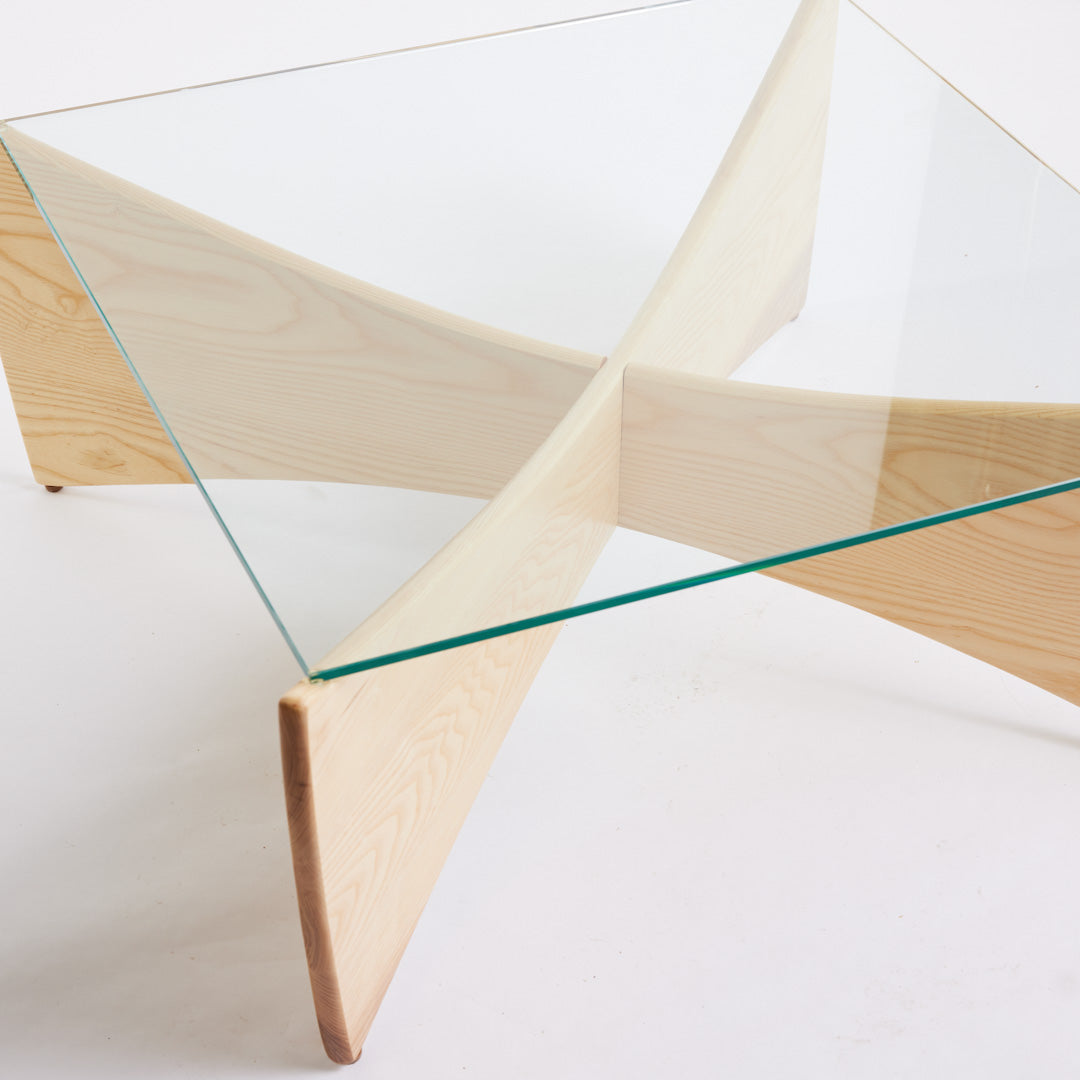 TH Brown Venus Coffee Table in Clear Ash with clear glass top, blending warm natural timber and sculptural form for modern Australian living.
