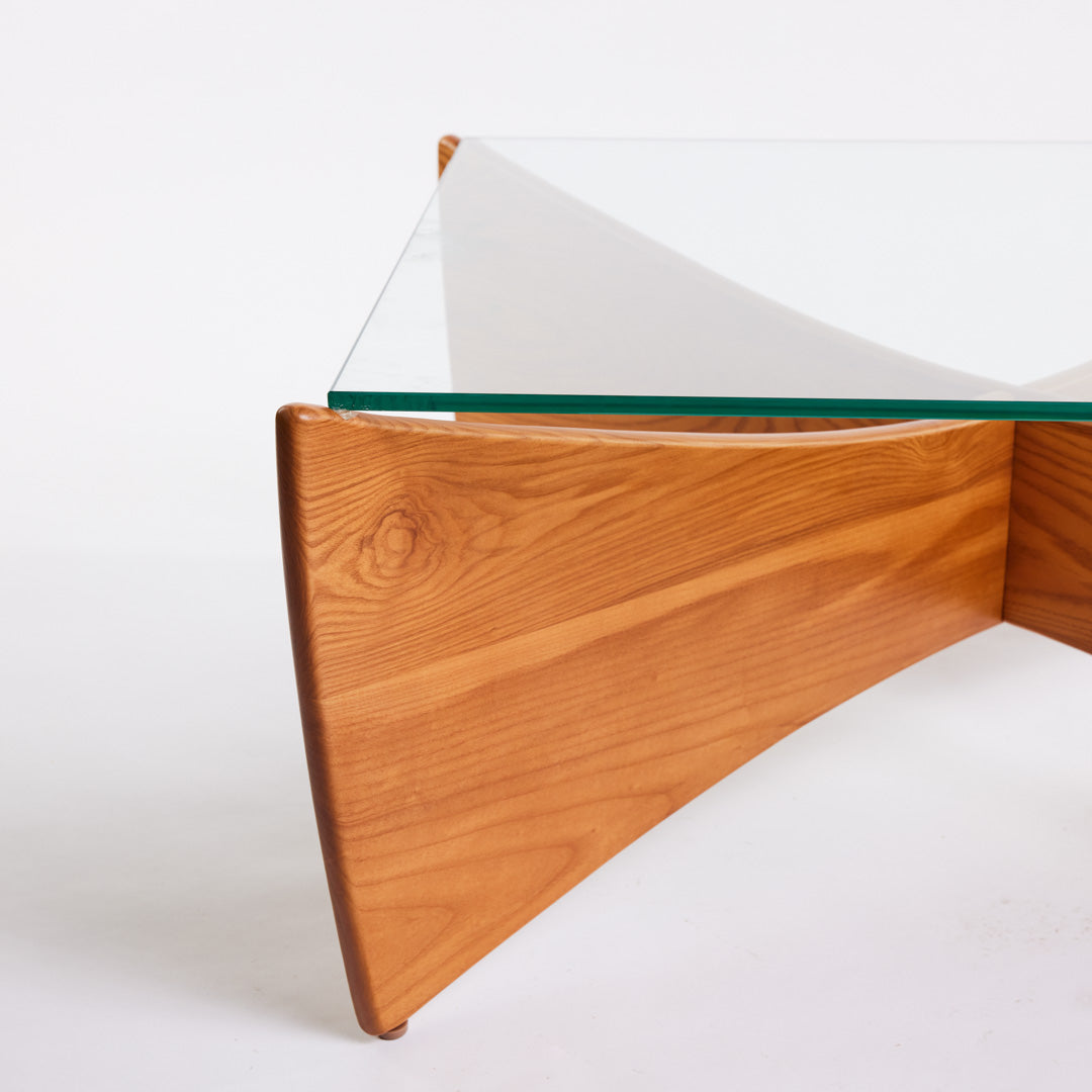 TH Brown Venus Coffee Table in Teak Ash with clear glass top, blending warm natural timber and sculptural form for modern Australian living.