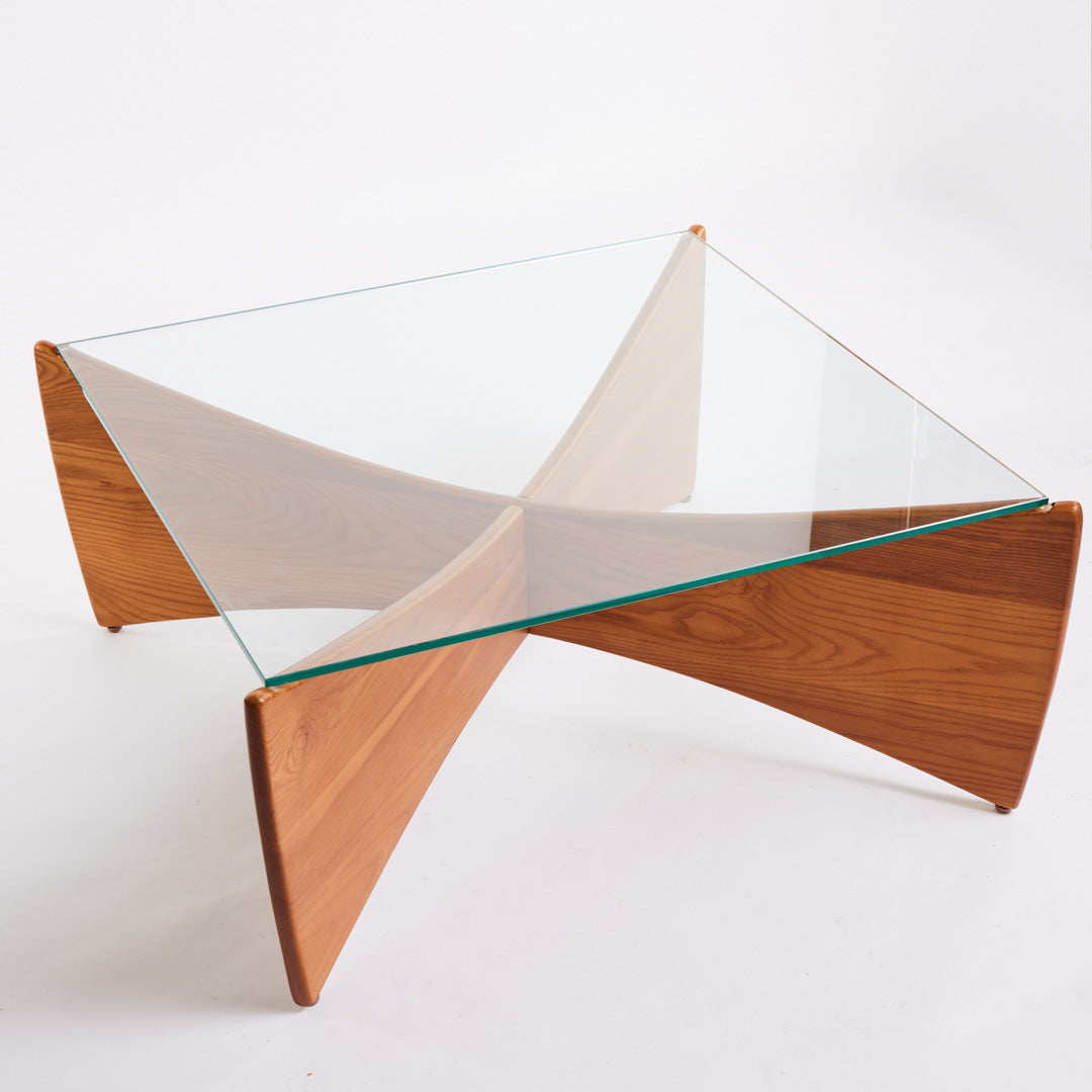 TH Brown Venus Coffee Table in Teak Ash with clear glass top, blending warm natural timber and sculptural form for modern Australian living.