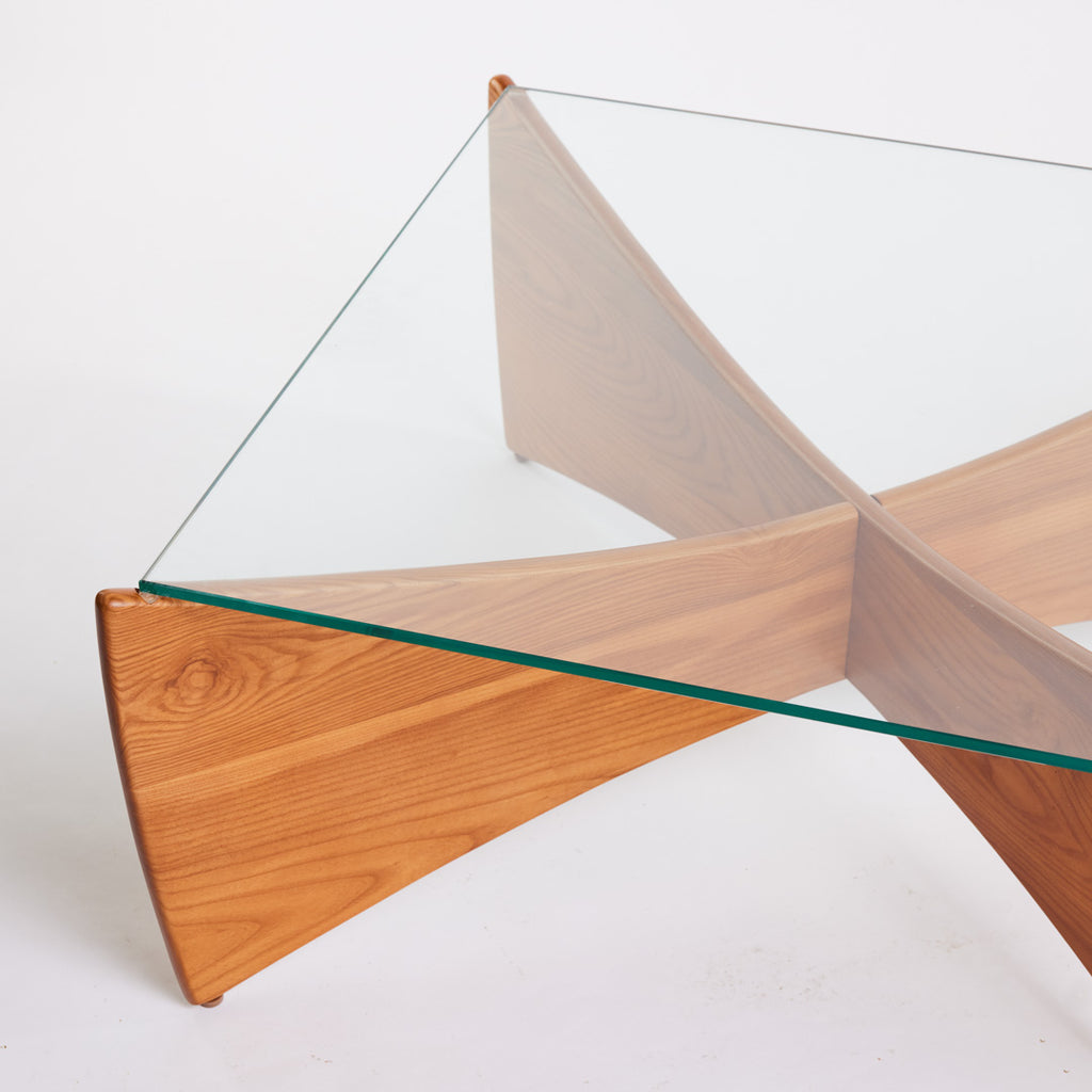 TH Brown Venus Coffee Table in Teak Ash with clear glass top, blending warm natural timber and sculptural form for modern Australian living.