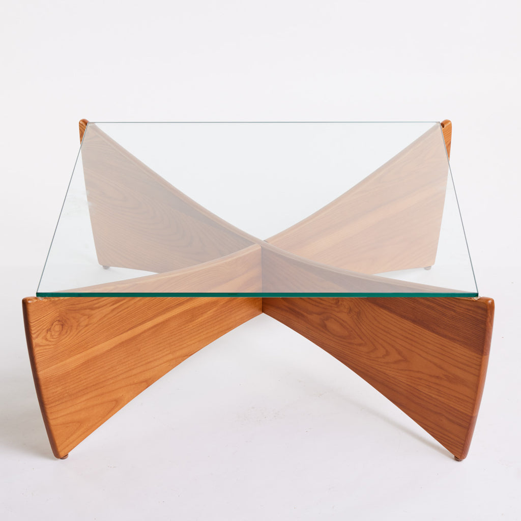 TH Brown Venus Coffee Table in Teak Ash with clear glass top, blending warm natural timber and sculptural form for modern Australian living.