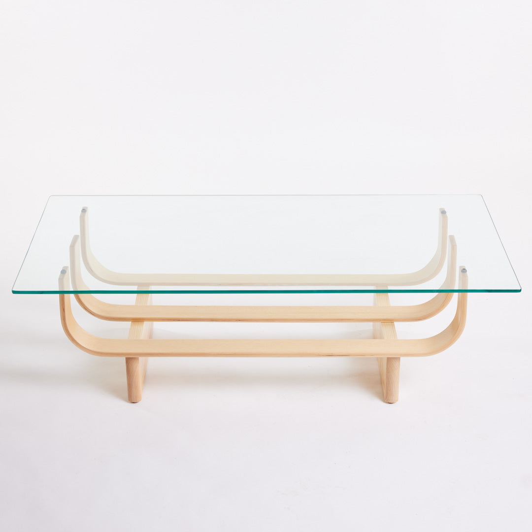 TH Brown Aquarius Coffee Table in Clear Ash with clear glass, blending natural timber warmth and sculptural form for timeless modern Australian living.