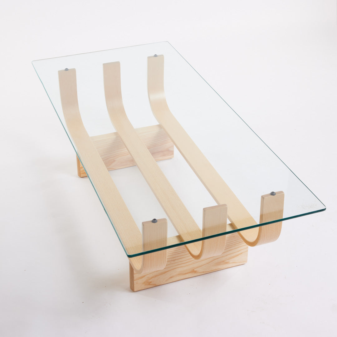 TH Brown Aquarius Coffee Table in Clear Ash with clear glass, blending natural timber warmth and sculptural form for timeless modern Australian living.