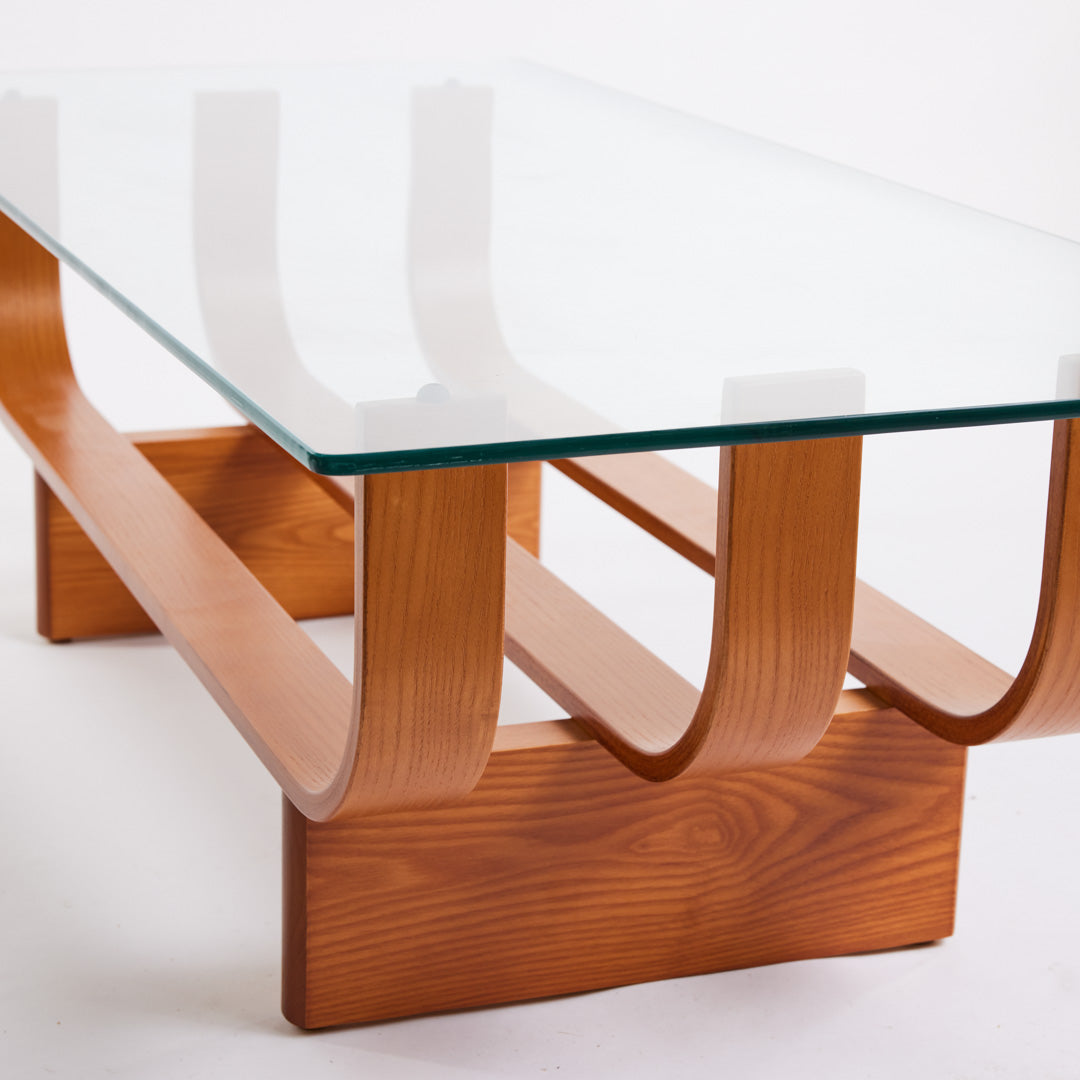 TH Brown Aquarius Coffee Table in Teak Ash with clear glass, blending natural timber warmth and sculptural form for timeless modern Australian living.