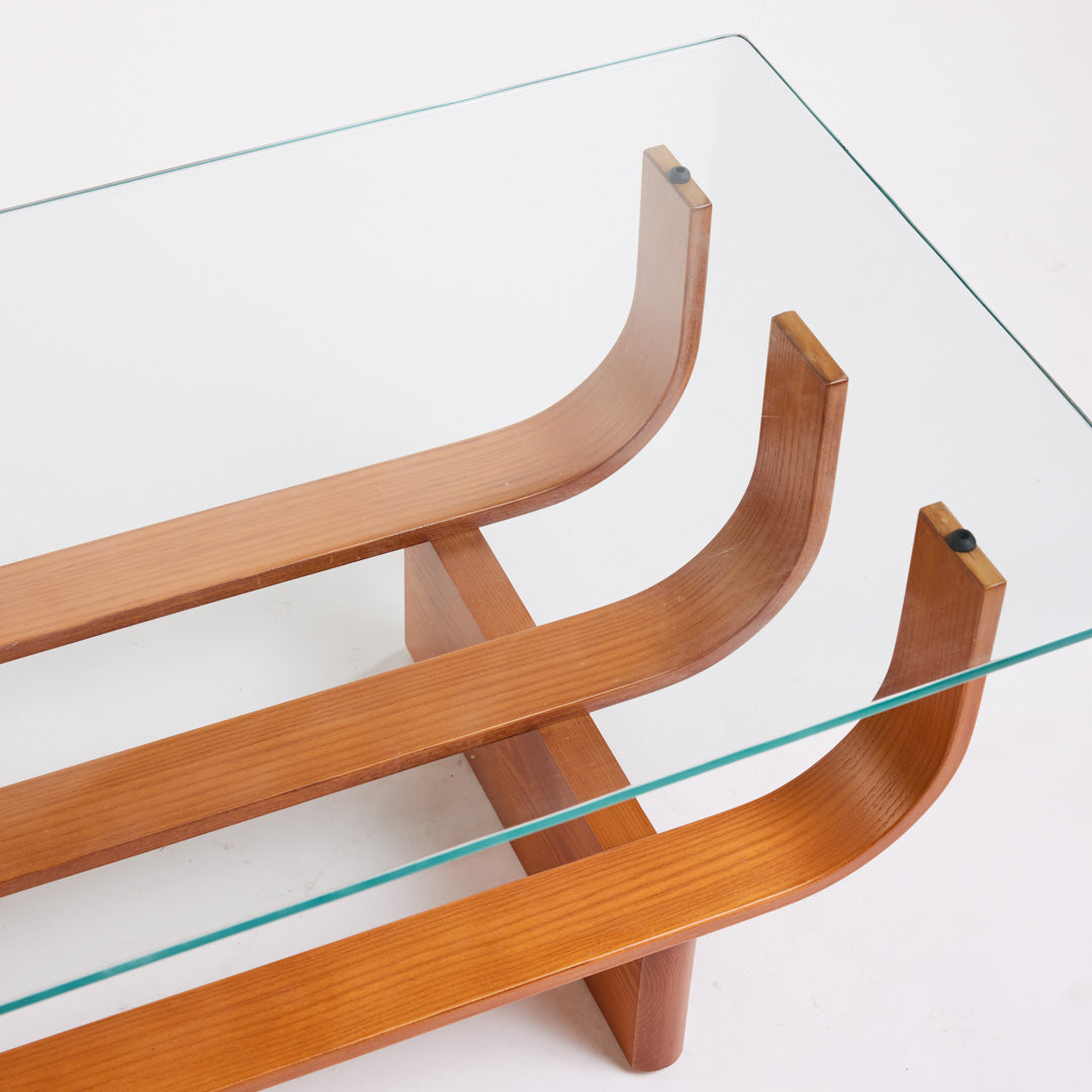 TH Brown Aquarius Coffee Table in Teak Ash with clear glass, blending natural timber warmth and sculptural form for timeless modern Australian living.