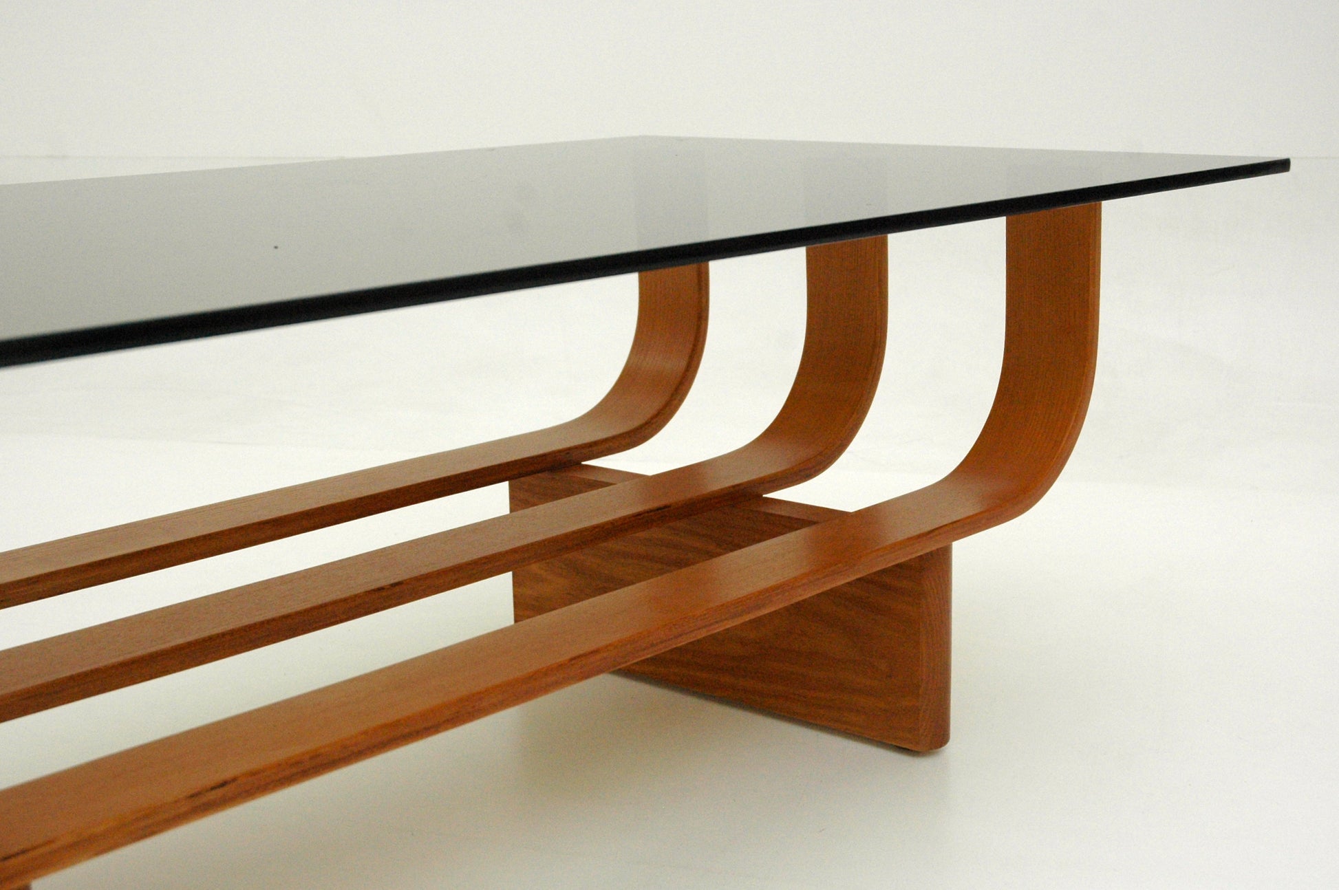 TH Brown Aquarius Coffee Table in Teak Ash with grey glass, blending natural timber warmth and sculptural form for timeless modern Australian living.
