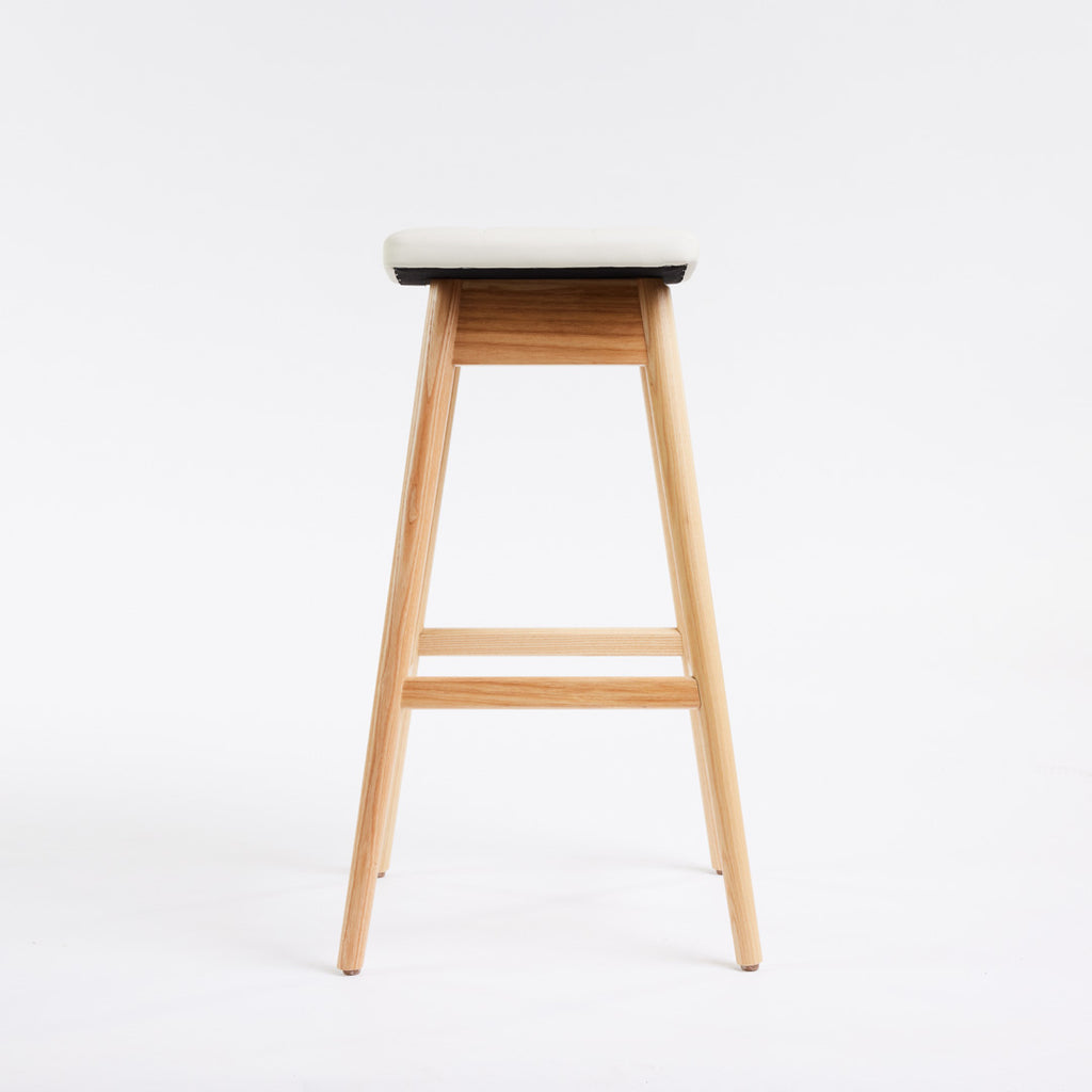 TH Brown Martelle Bar Stool in Arctic White with Clear Ash frame, blending crisp upholstery and natural timber for fresh modern Australian living.
