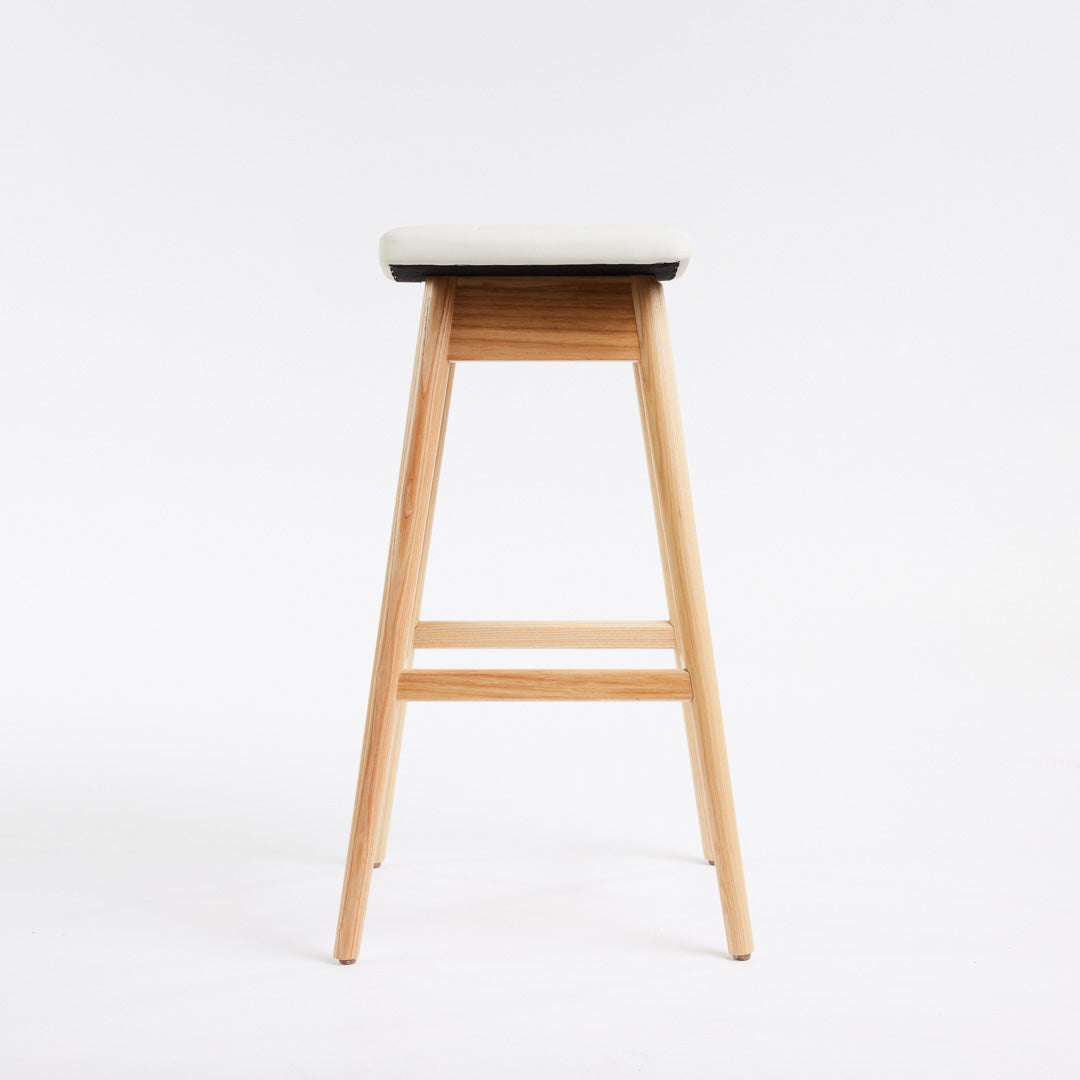 TH Brown Martelle Bar Stool in Arctic White with Clear Ash frame, blending crisp upholstery and natural timber for fresh modern Australian living.