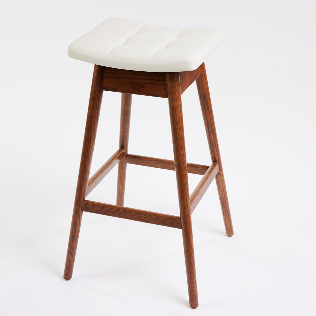 TH Brown Martelle Bar Stool in Arctic White with Dark Ash frame, blending crisp upholstery and rich timber tones for refined modern Australian living.
