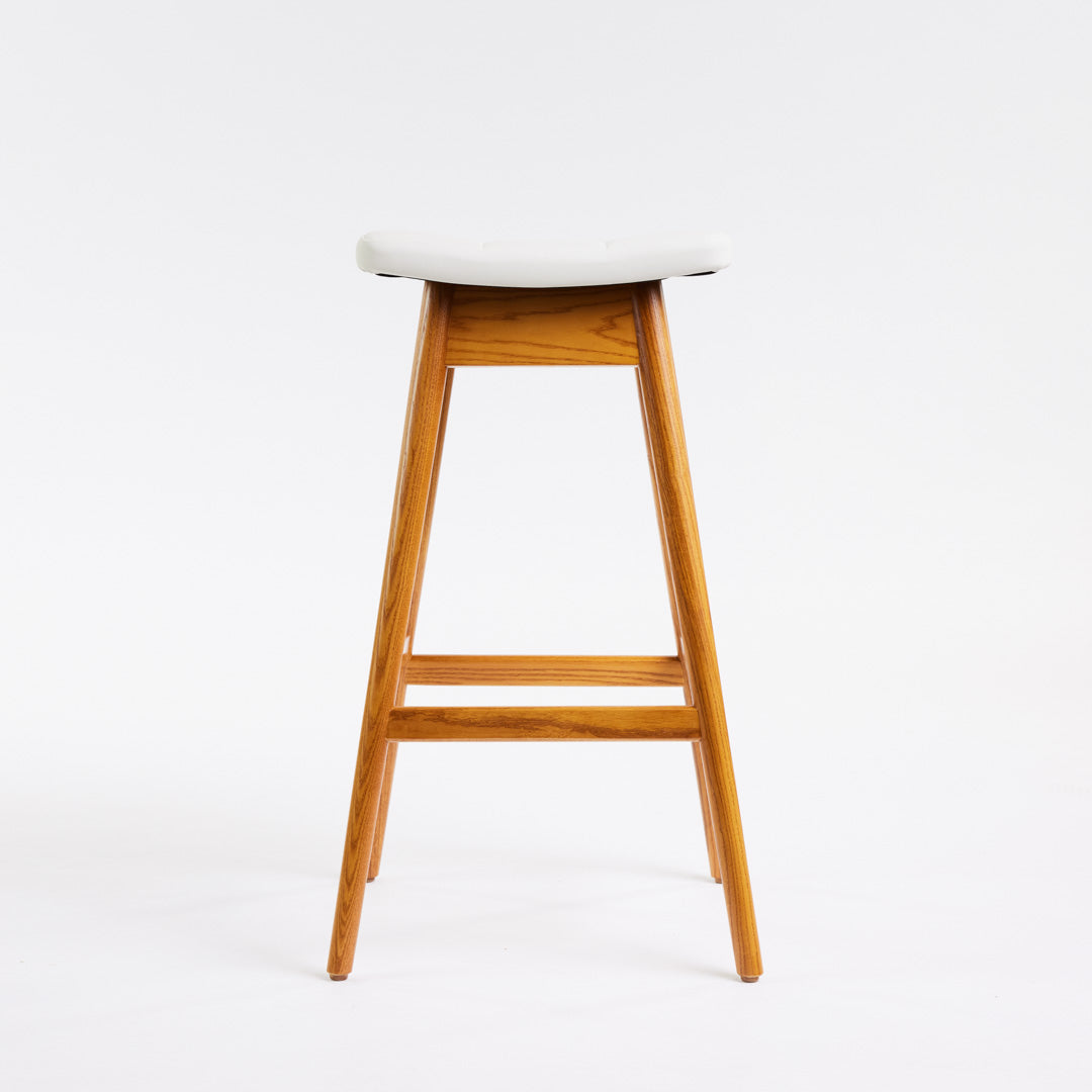 TH Brown Martelle Bar Stool in Arctic White with Light Ash frame, blending crisp upholstery and pale timber for fresh modern Australian living.