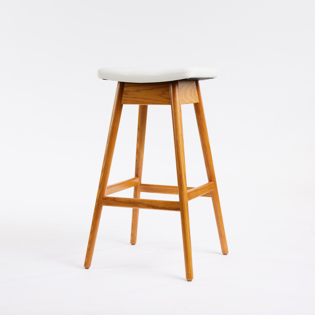 TH Brown Martelle Bar Stool in Arctic White with Light Ash frame, blending crisp upholstery and pale timber for fresh modern Australian living.