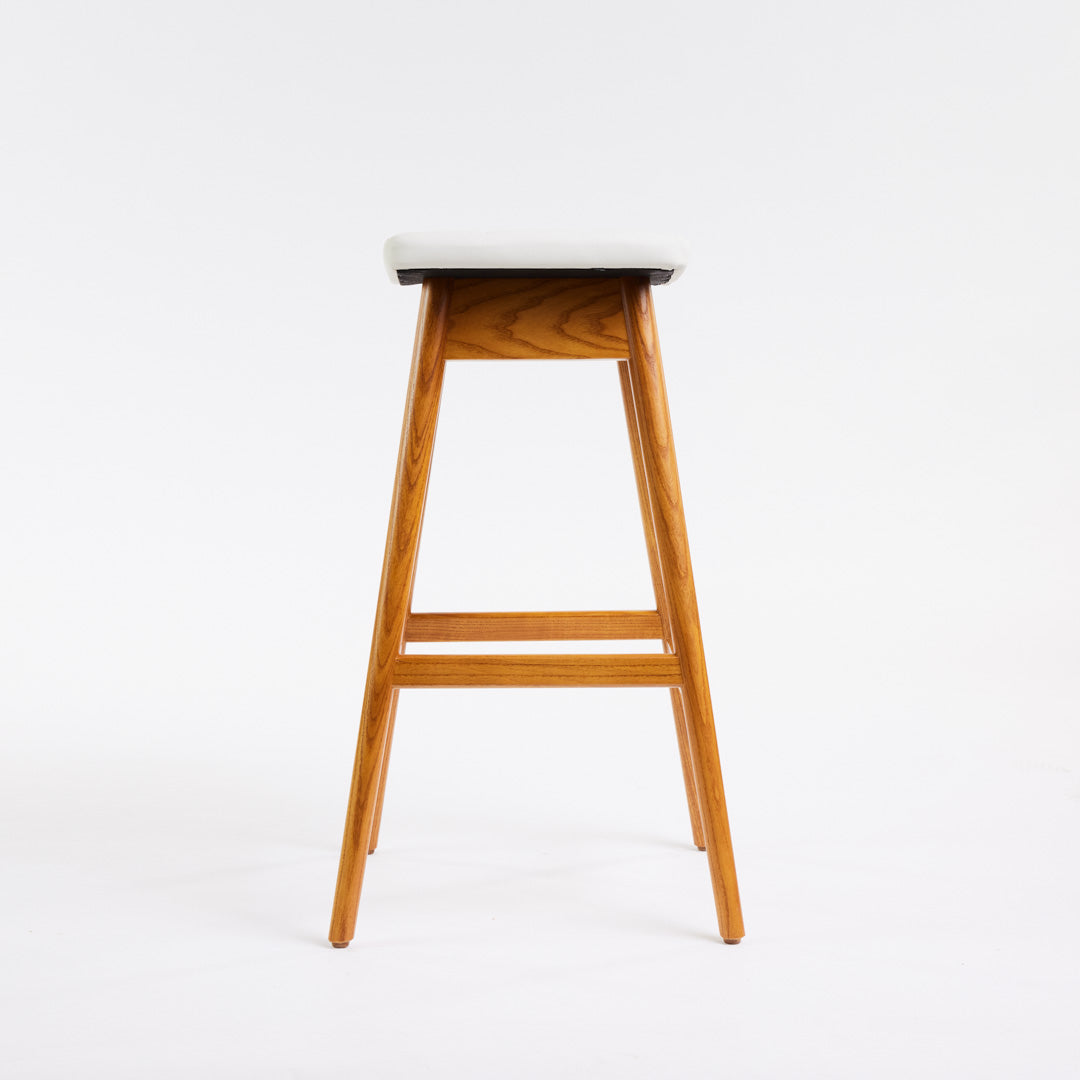TH Brown Martelle Bar Stool in Arctic White with Light Ash frame, blending crisp upholstery and pale timber for fresh modern Australian living.