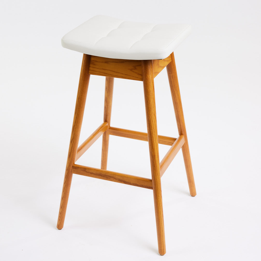 TH Brown Martelle Bar Stool in Arctic White with Light Ash frame, blending crisp upholstery and pale timber for fresh modern Australian living.