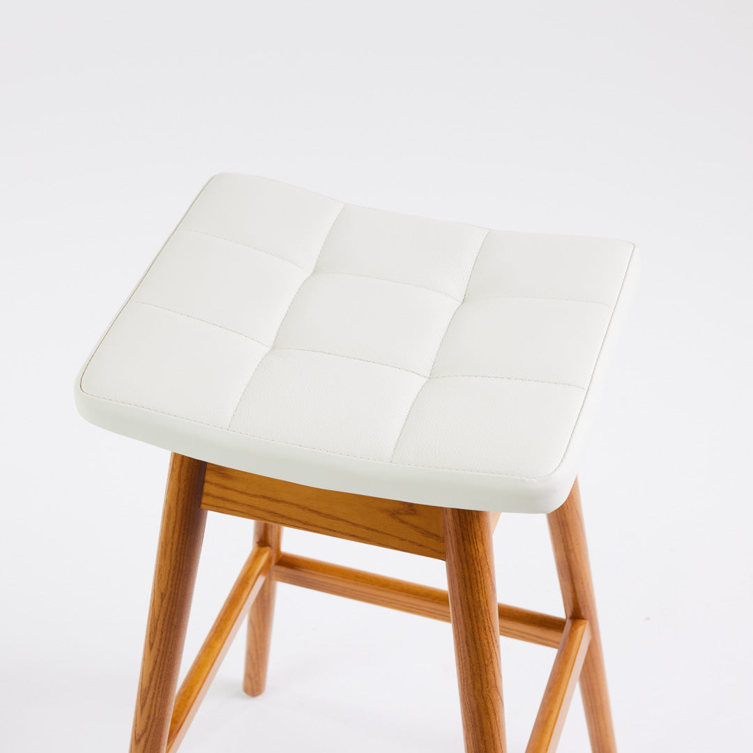TH Brown Martelle Bar Stool in Arctic White with Light Ash frame, blending crisp upholstery and pale timber for fresh modern Australian living.