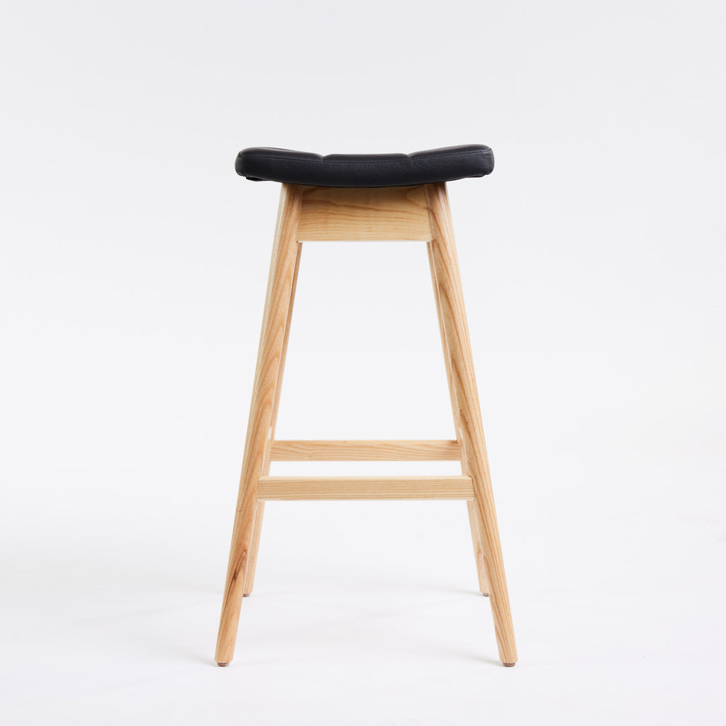TH Brown Martelle Bar Stool in Black with Clear Ash frame, blending bold upholstery and natural timber for refined modern Australian living.