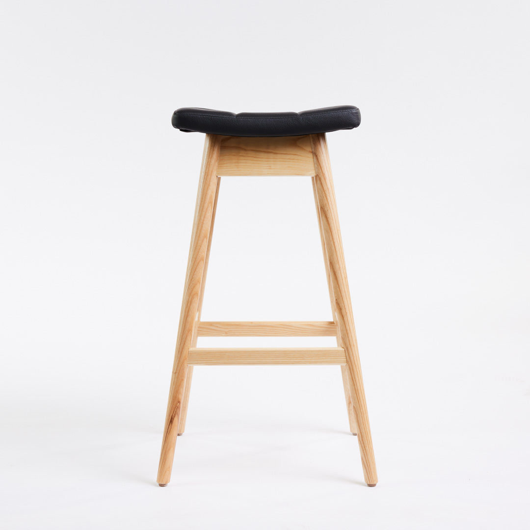 TH Brown Martelle Bar Stool in Black with Clear Ash frame, blending bold upholstery and natural timber for refined modern Australian living.