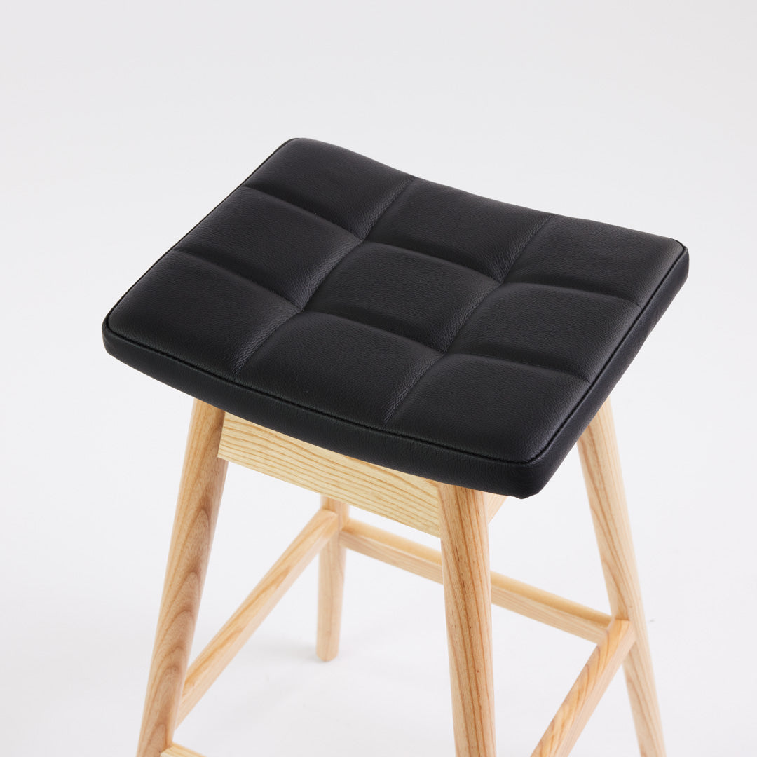 TH Brown Martelle Bar Stool in Black with Clear Ash frame, blending bold upholstery and natural timber for refined modern Australian living.