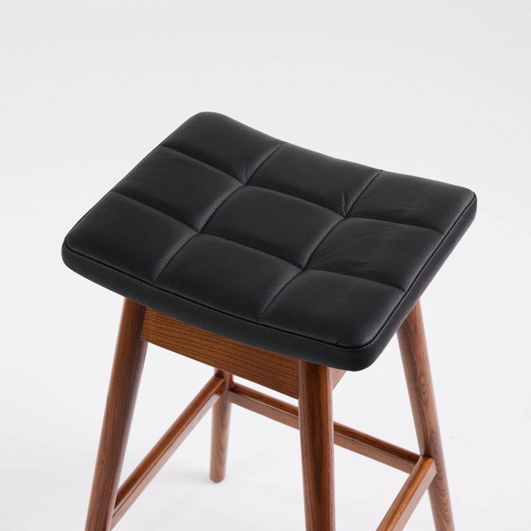 TH Brown Martelle Bar Stool in Black with Dark Ash frame, blending bold upholstery and rich timber tones for sophisticated modern Australian living.