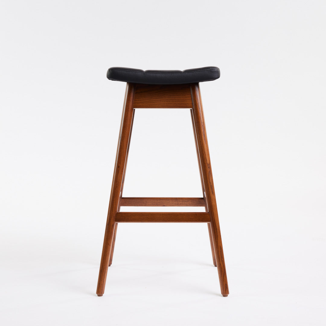 TH Brown Martelle Bar Stool in Black with Dark Ash frame, blending bold upholstery and rich timber tones for sophisticated modern Australian living.