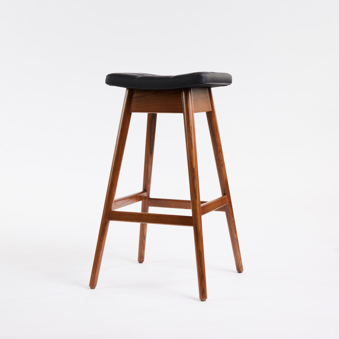 TH Brown Martelle Bar Stool in Black with Dark Ash frame, blending bold upholstery and rich timber tones for sophisticated modern Australian living.