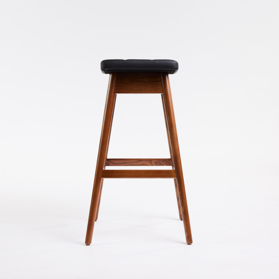 TH Brown Martelle Bar Stool in Black with Dark Ash frame, blending bold upholstery and rich timber tones for sophisticated modern Australian living.