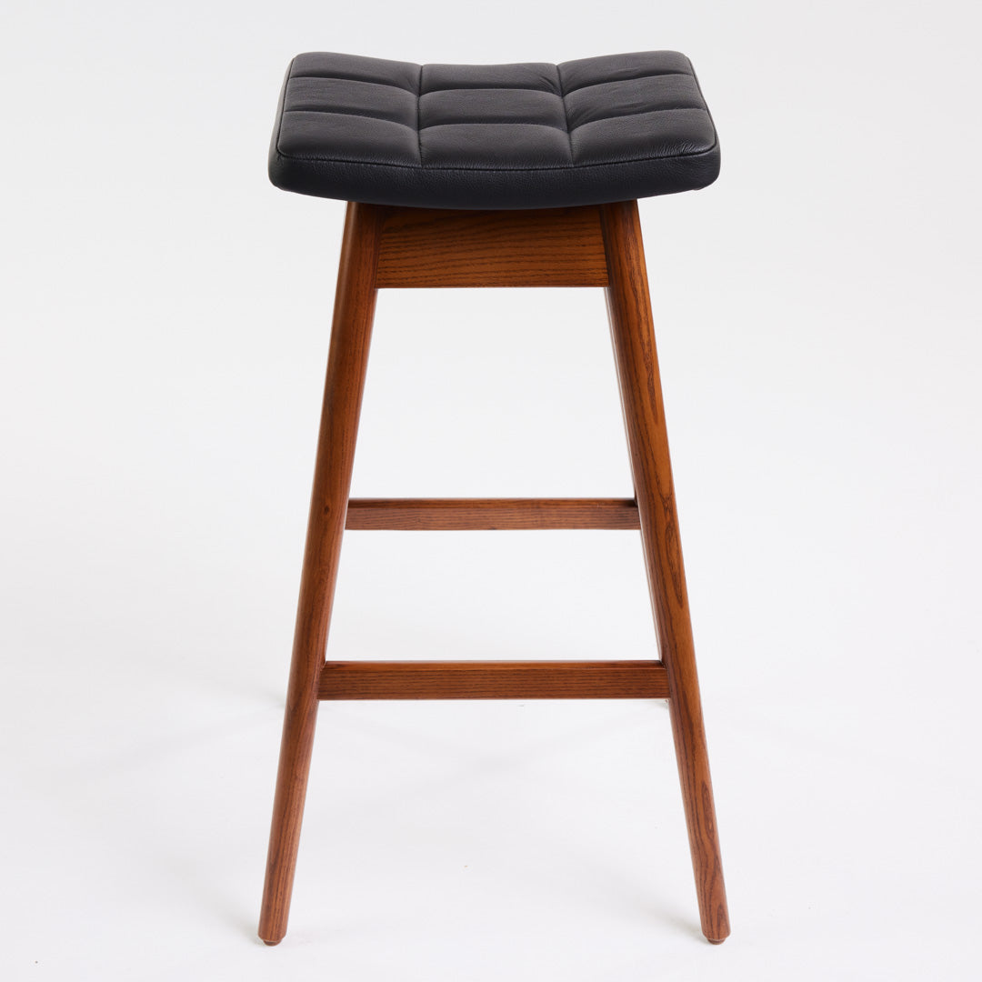 TH Brown Martelle Bar Stool in Black with Dark Ash frame, blending bold upholstery and rich timber tones for sophisticated modern Australian living.