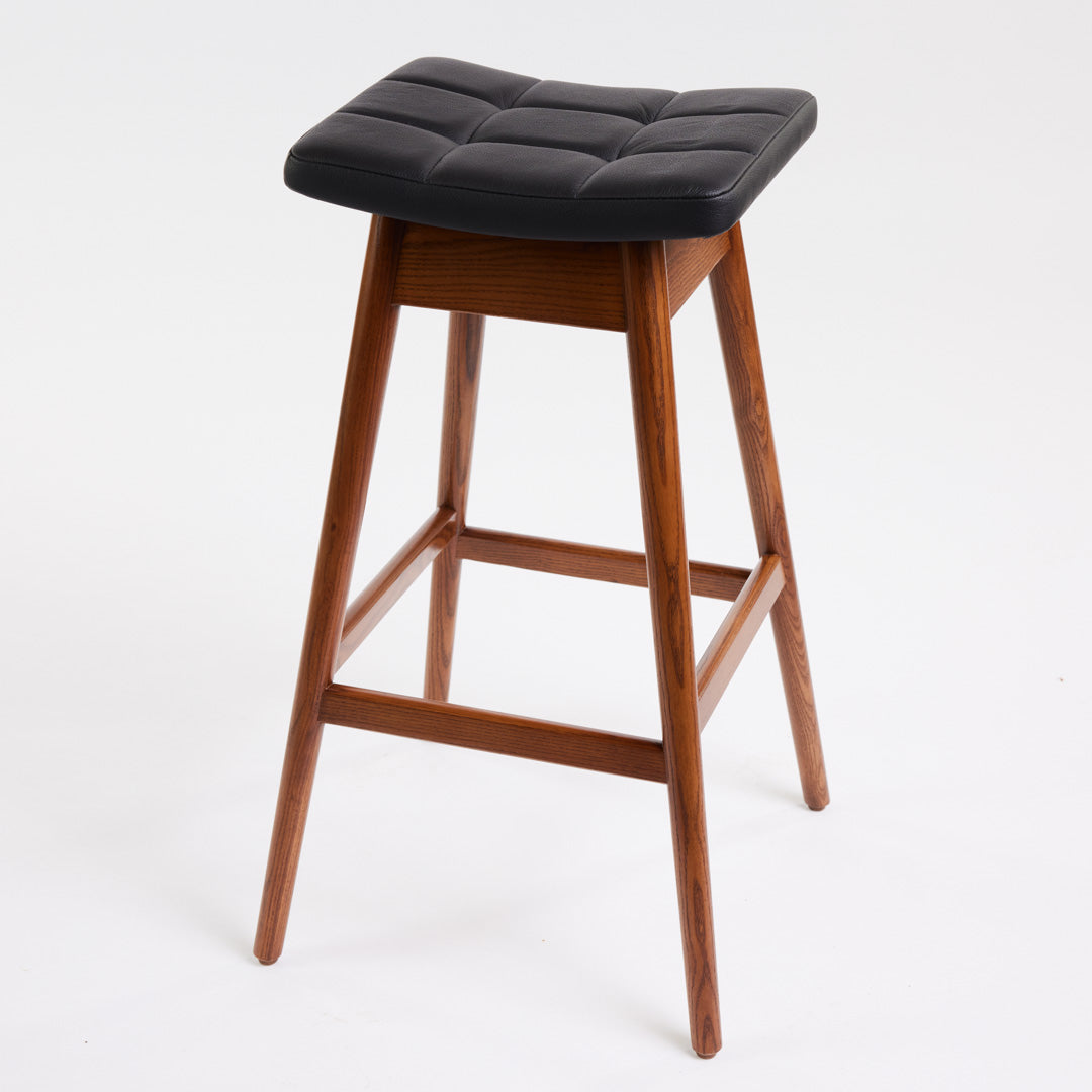 TH Brown Martelle Bar Stool in Black with Dark Ash frame, blending bold upholstery and rich timber tones for sophisticated modern Australian living.