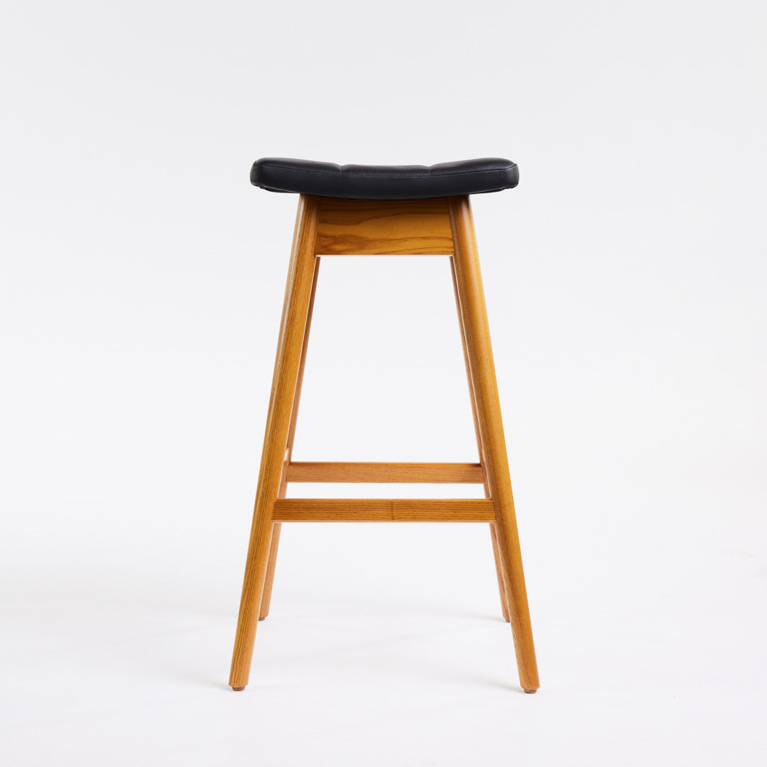 TH Brown Martelle Bar Stool in Black with Light Ash frame, blending bold upholstery and pale timber for striking modern Australian living.