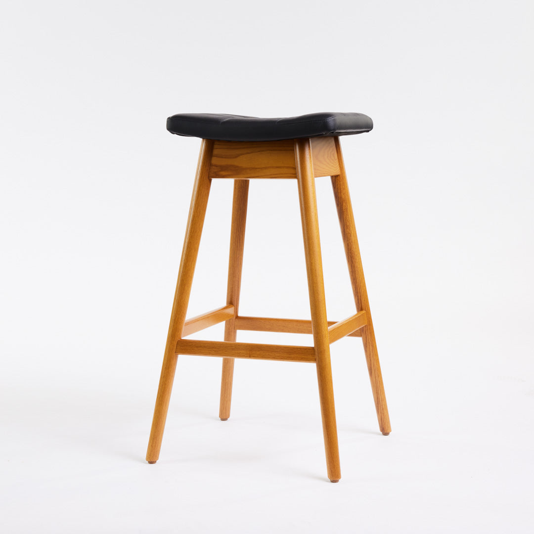 TH Brown Martelle Bar Stool in Black with Light Ash frame, blending bold upholstery and pale timber for striking modern Australian living