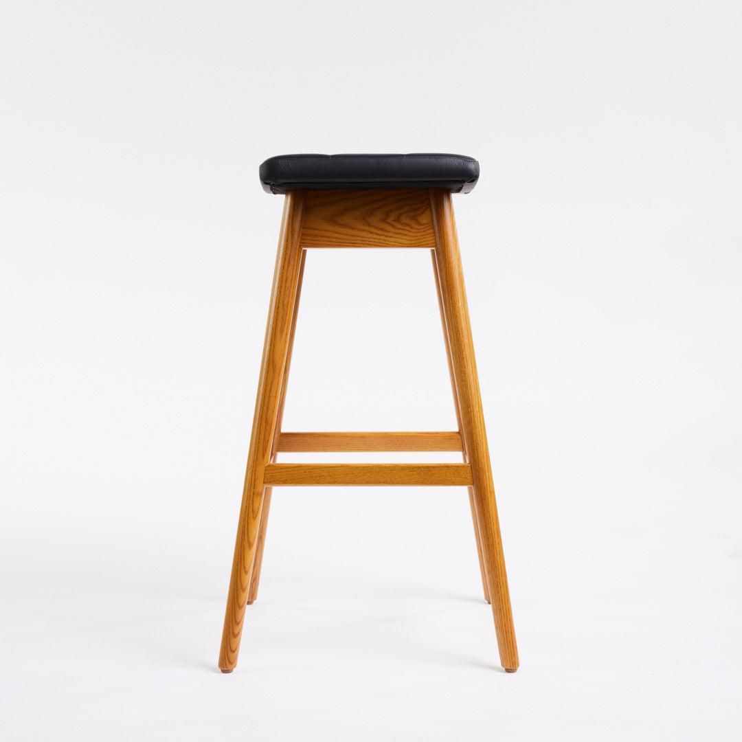 TH Brown Martelle Bar Stool in Black with Light Ash frame, blending bold upholstery and pale timber for striking modern Australian living