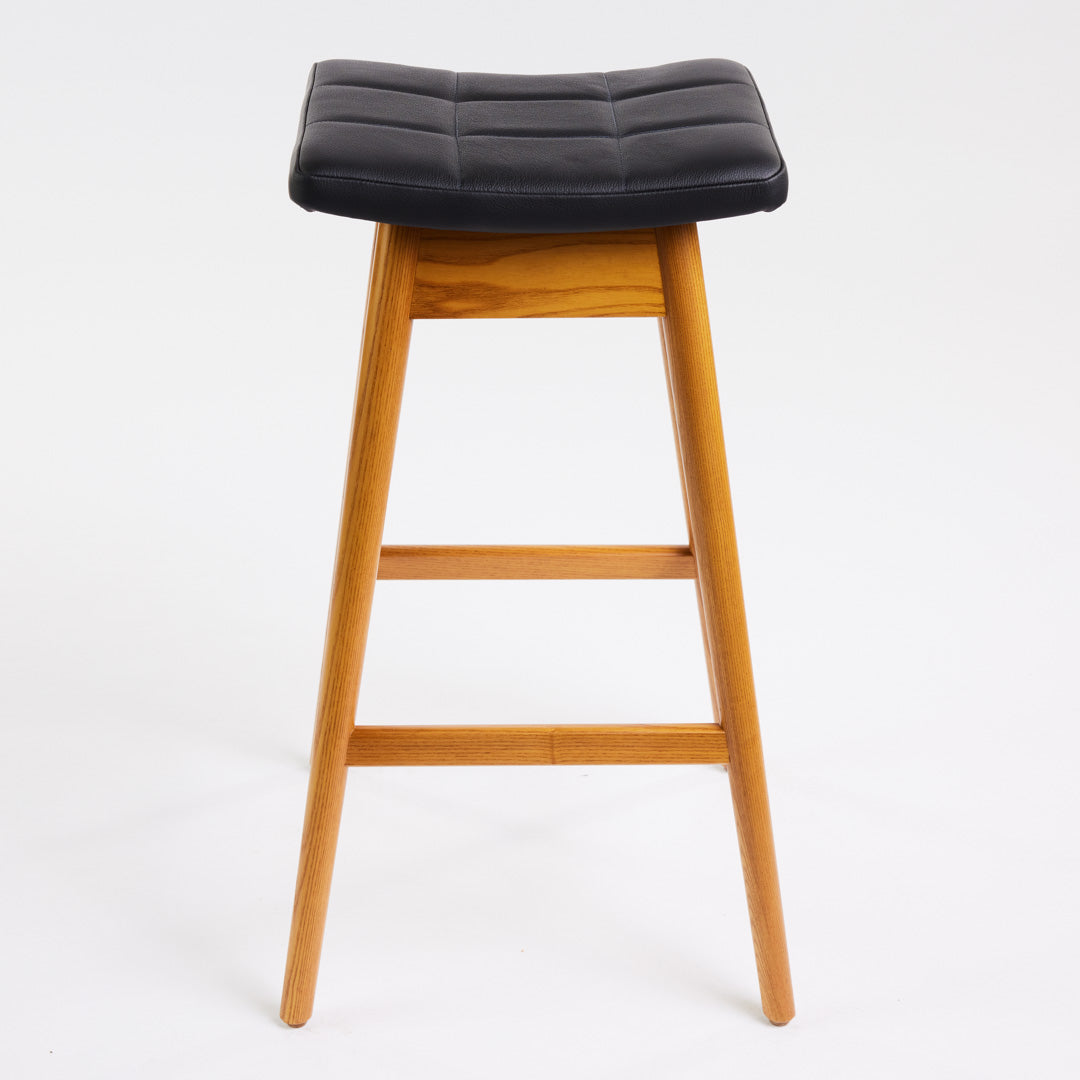 TH Brown Martelle Bar Stool in Black with Light Ash frame, blending bold upholstery and pale timber for striking modern Australian living.
