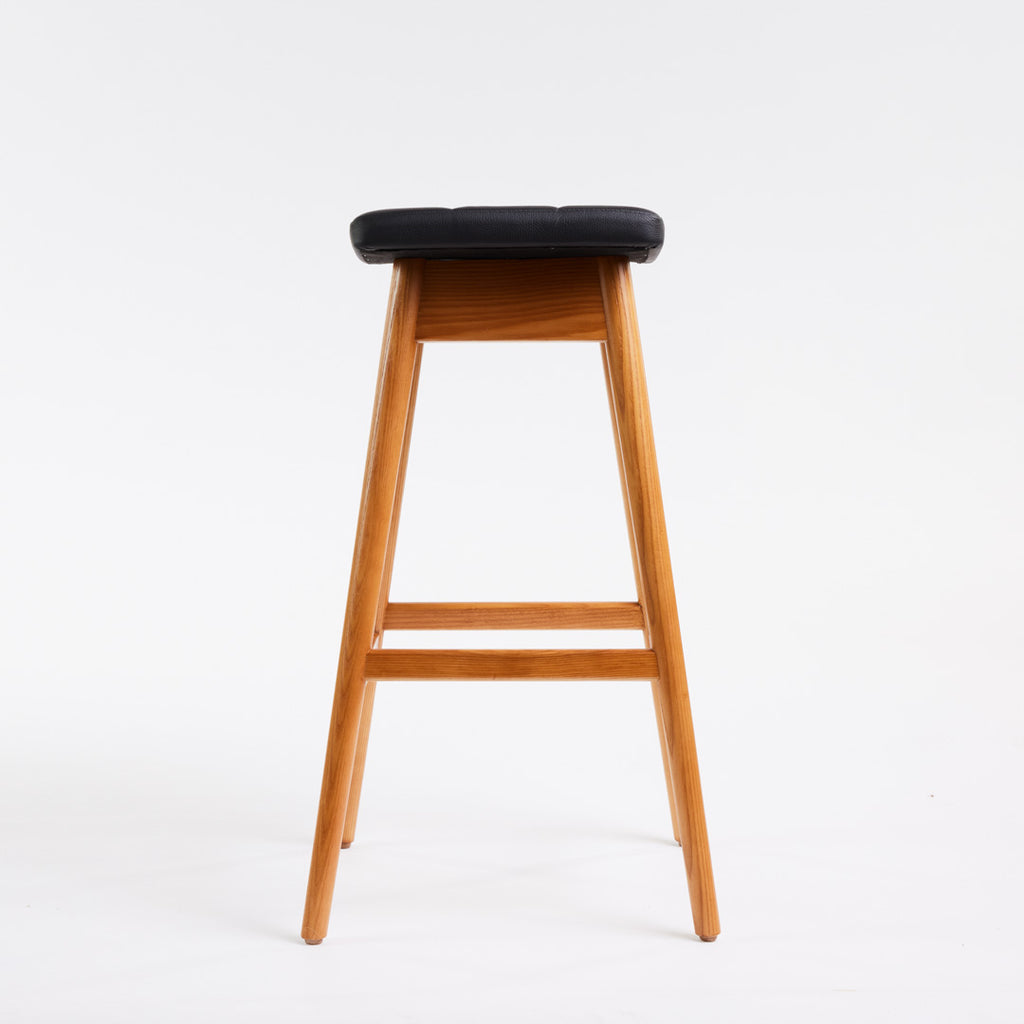 TH Brown Martelle Bar Stool in Black with Teak Ash frame, blending bold upholstery and warm timber for sophisticated modern Australian living.