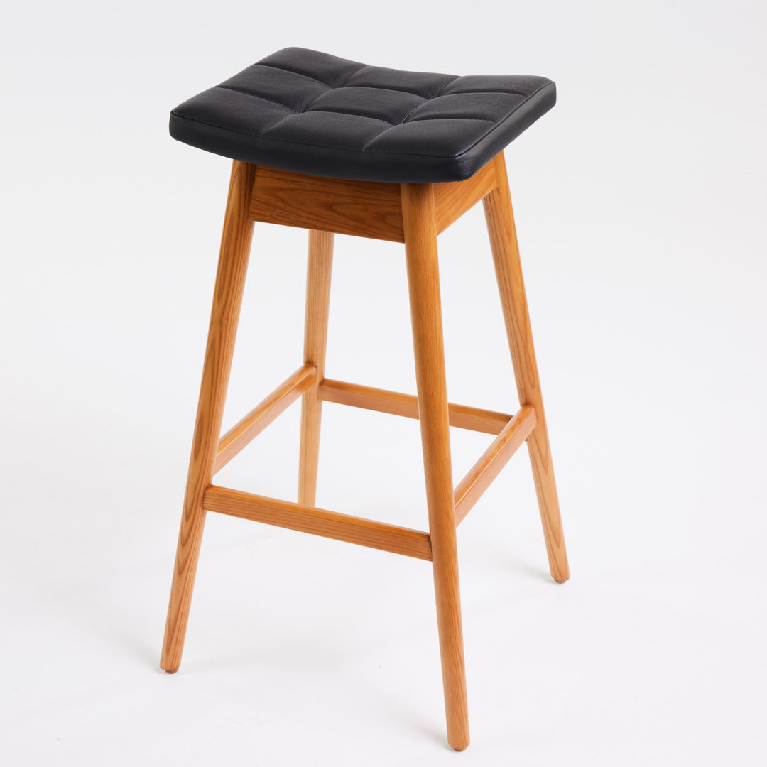TH Brown Martelle Bar Stool in Black with Teak Ash frame, blending bold upholstery and warm timber for sophisticated modern Australian living.