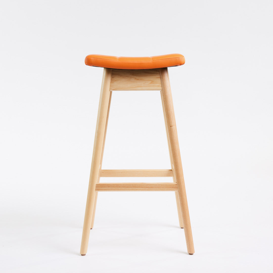 TH Brown Martelle Bar Stool in Calypso Orange with Clear Ash frame, blending vibrant colour and natural timber for playful modern Australian living.