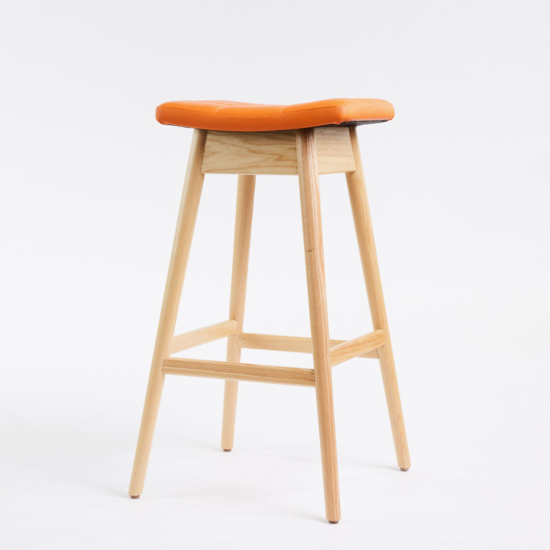 TH Brown Martelle Bar Stool in Calypso Orange with Clear Ash frame, blending vibrant colour and natural timber for playful modern Australian living.