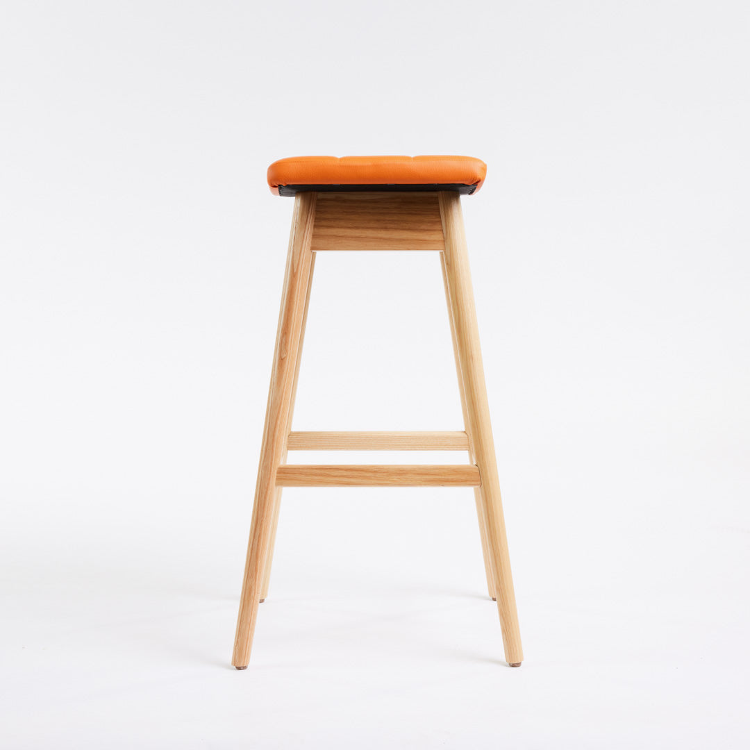TH Brown Martelle Bar Stool in Calypso Orange with Clear Ash frame, blending vibrant colour and natural timber for playful modern Australian living.