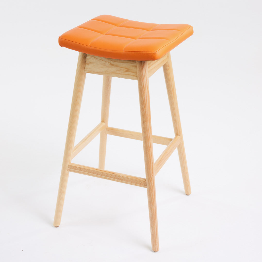 TH Brown Martelle Bar Stool in Calypso Orange with Clear Ash frame, blending vibrant colour and natural timber for playful modern Australian living.