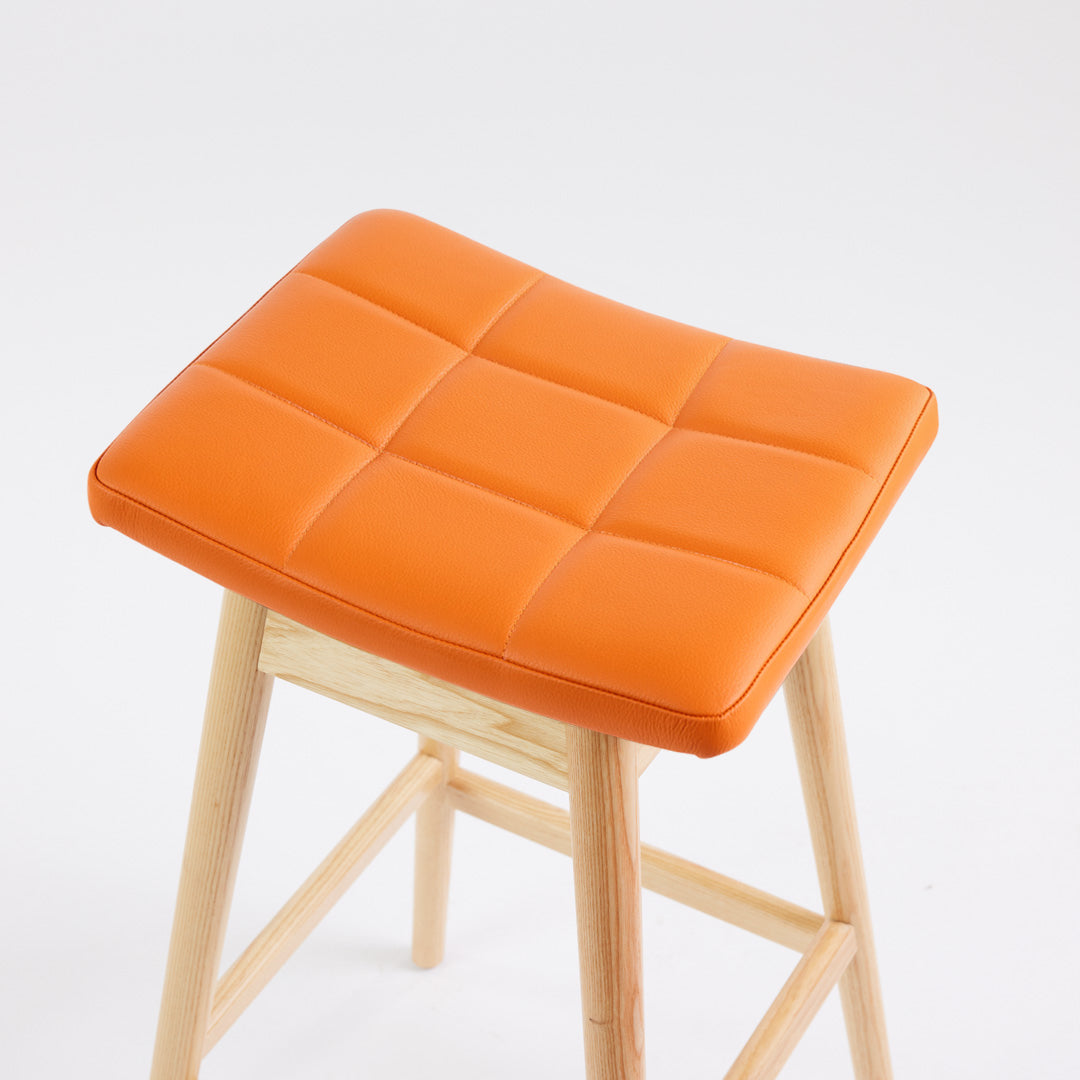TH Brown Martelle Bar Stool in Calypso Orange with Clear Ash frame, blending vibrant colour and natural timber for playful modern Australian living.